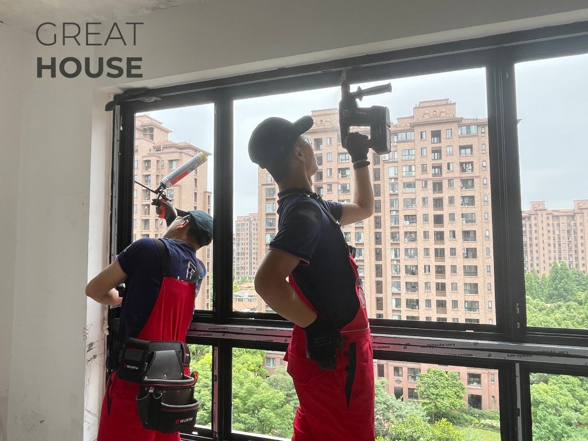 Installation team sealing and finishing an aluminum window